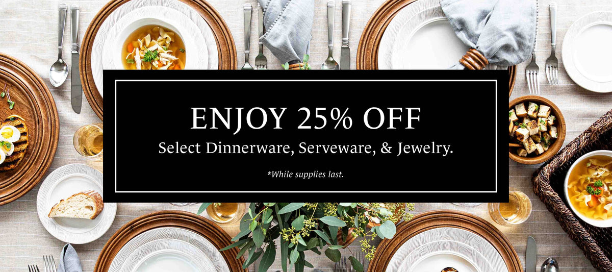 A promotional banner featuring a black central rectangle with white text reading 'ENJOY 25% OFF Select Dinnerware, Serveware, & Jewelry.' over a styled overhead dining table scene with plates, bowls, cutlery, napkins, and food.