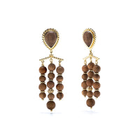 Hand carved Teak adorned with gold, these chandelier earrings frame your face with glinting gold and rich dark wood.