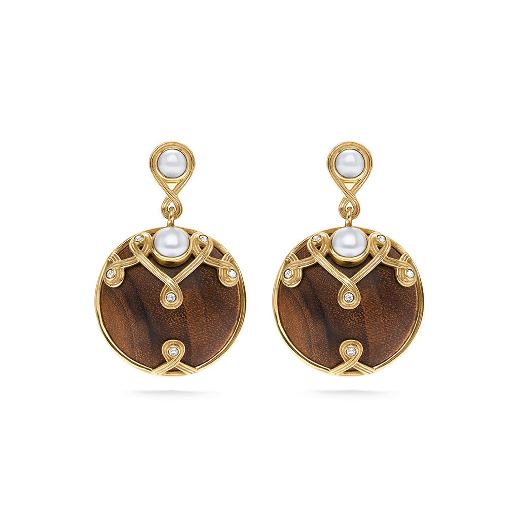 These alluring earrings are a paradoxical pairing of lustrous pearls and hand-carved teak wood accented with tiny crystals. These are stunning when paired with our Elizabetta Pearl Necklace or any of our other teak wood necklaces.