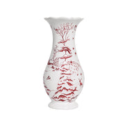 A white ceramic vase with a red toile-style winter landscape print, featuring a tree, birds, and outdoor landscape set against a plain white background.