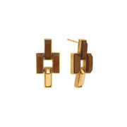 A pair of gold geometric drop earrings with dark brown rectangular inlays, shown against a plain white background.