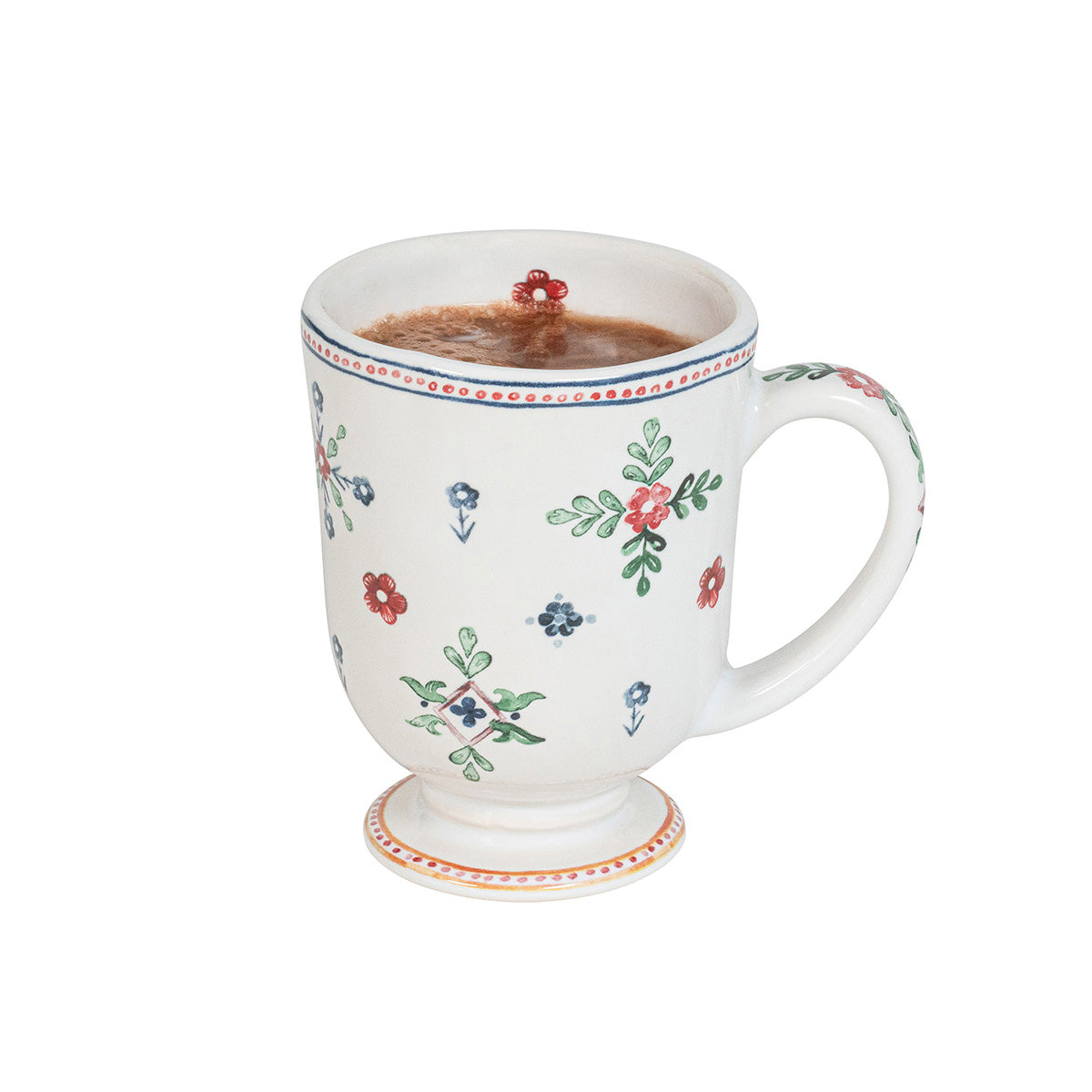 Decorative mug with floral patterns filled with a hot beverage on a white background