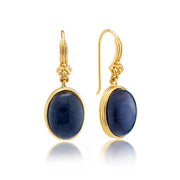 Gold earrings with blue stones on a white background