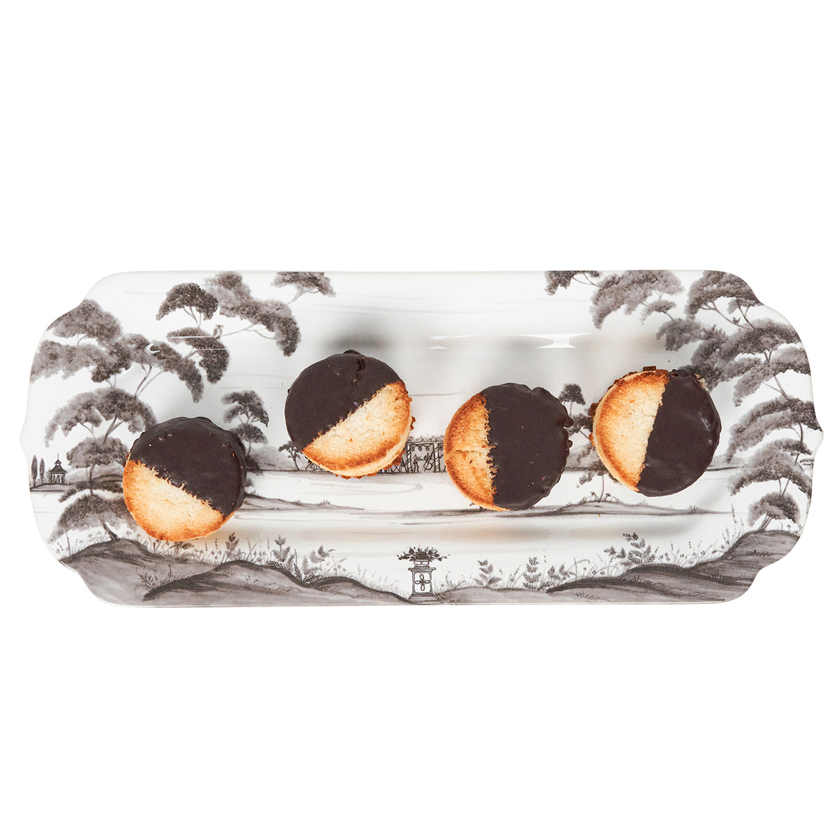 Rectangular plate with black and white landscape design featuring four cookies.