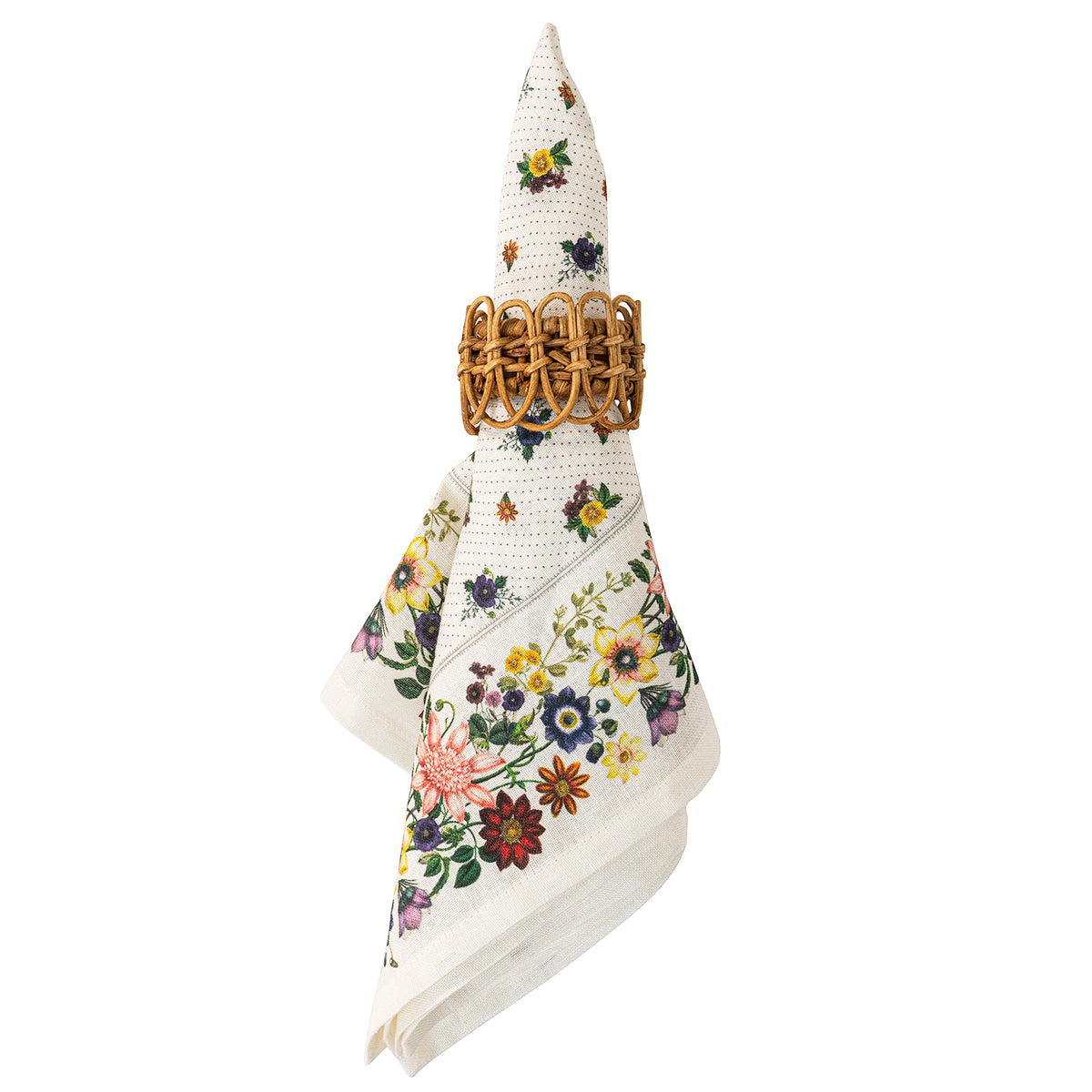 A folded cream-colored linen napkin with a colorful floral print, held in place by a woven brown paper napkin ring, shown against a plain white background.