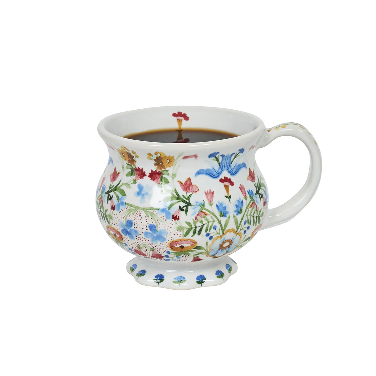 Decorative mug with floral pattern containing coffee on a white background