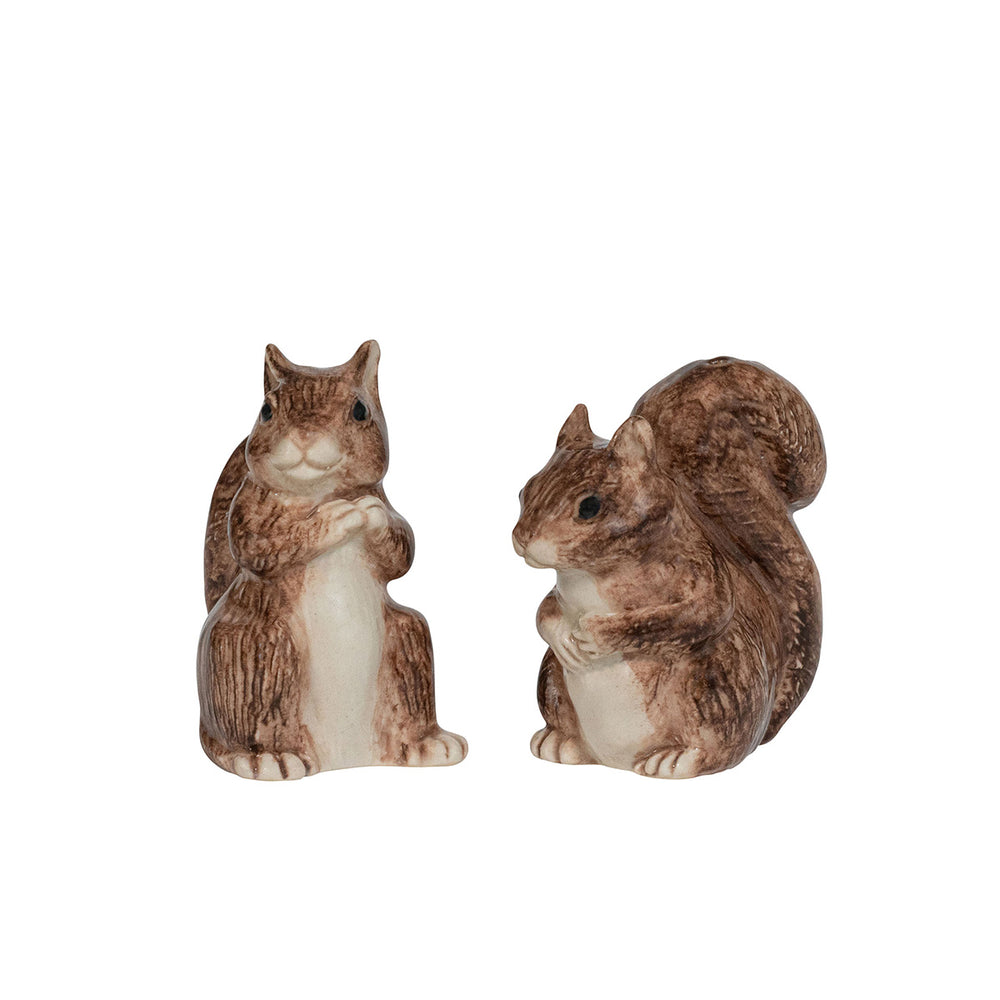 Two squirrel figurines on a white background