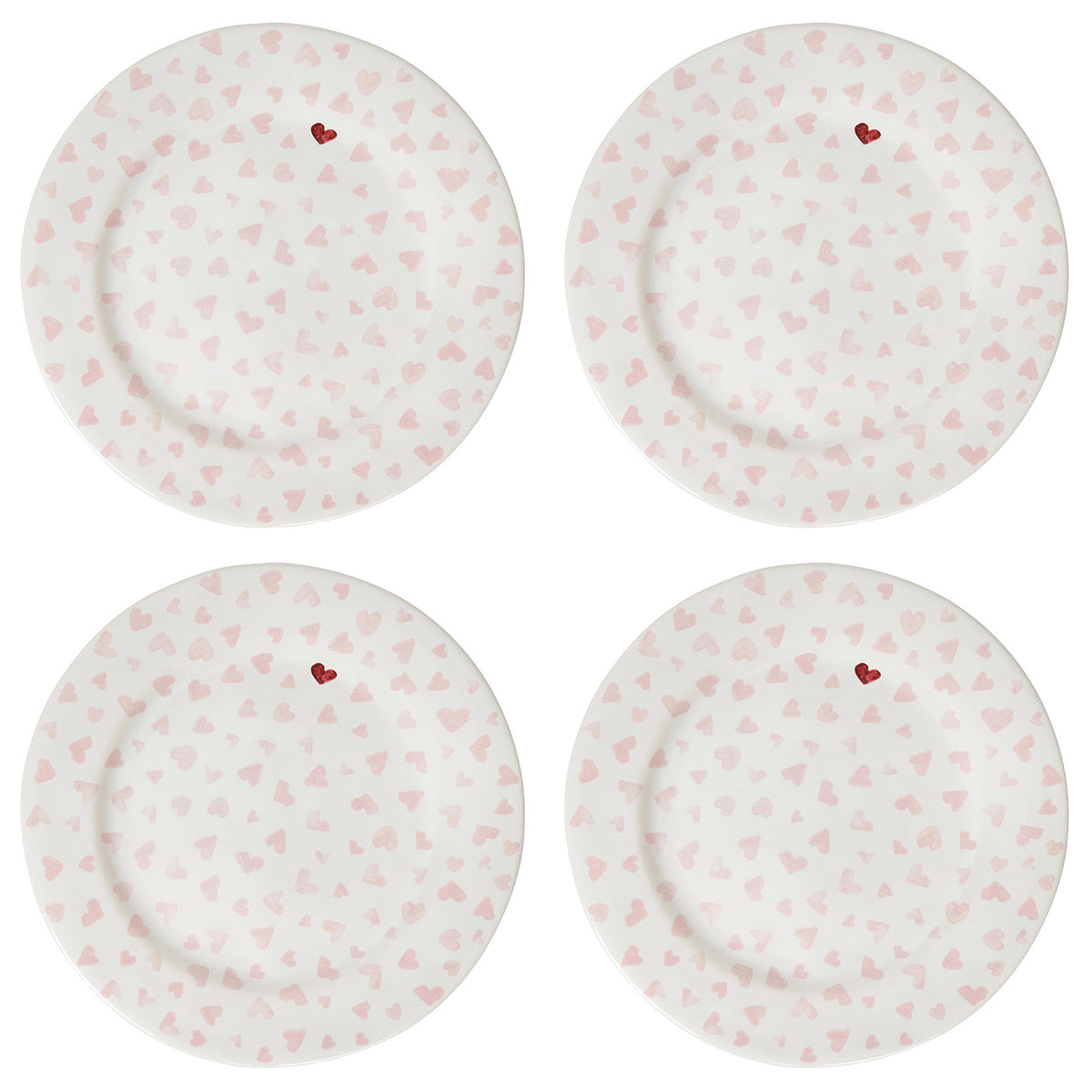 Four white plates with pink heart patterns on a white background