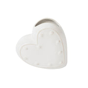 Heart-shaped white ceramic planter with decorative holes on a white background