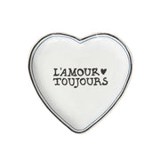 Heart-shaped white plate with 'L'Amour Toujours' text on a white background