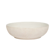 White ceramic bowl with textured surface on a white background