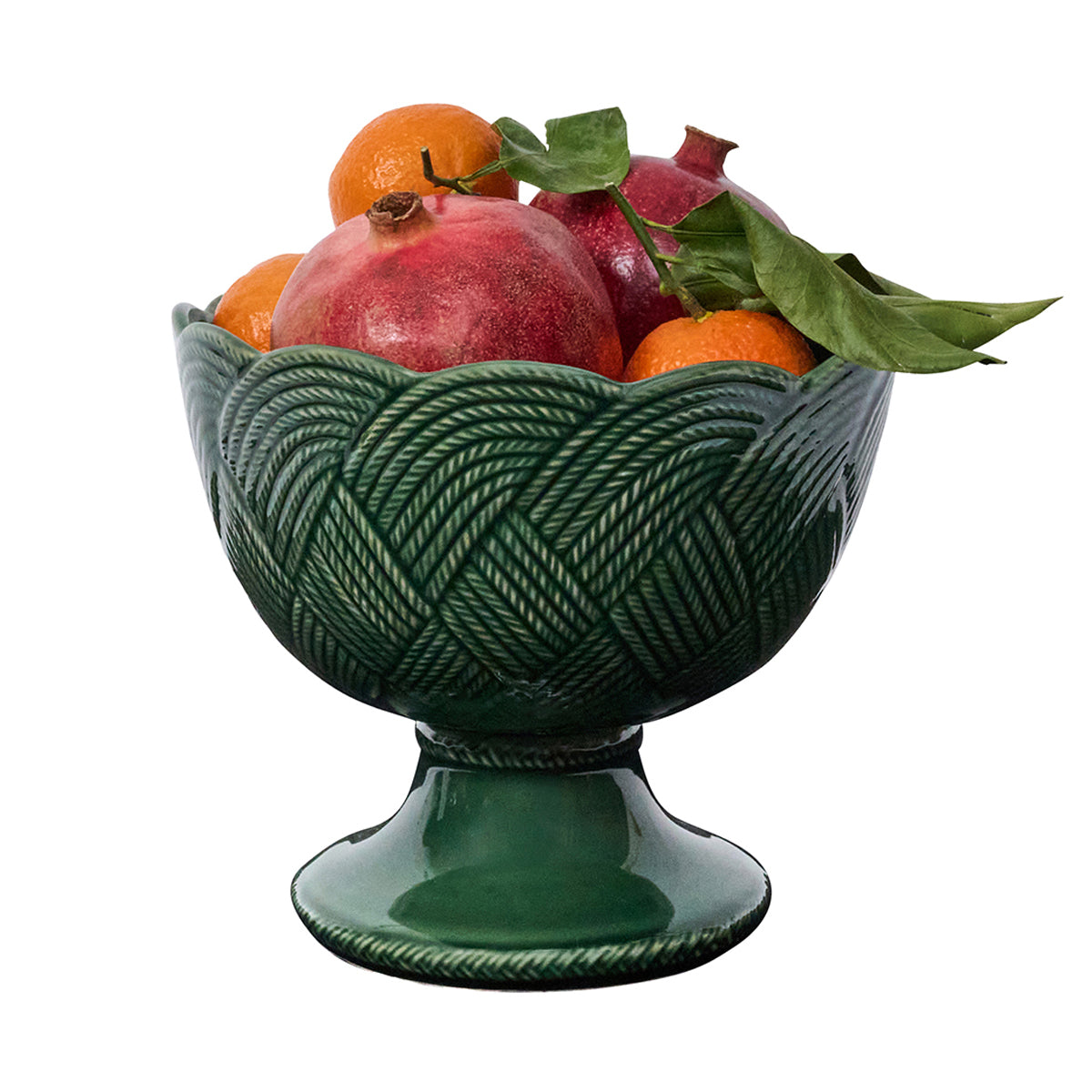 Decorative green bowl with fruits on a white background