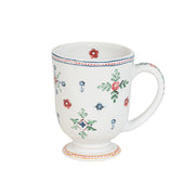 White mug with floral patterns on a white background