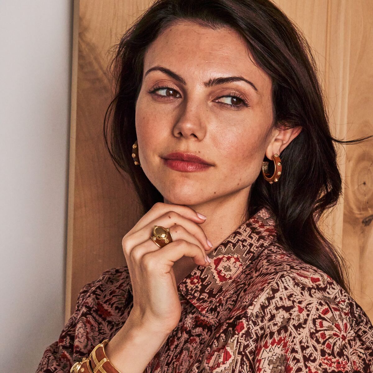 Woman with teak and gold jewelry