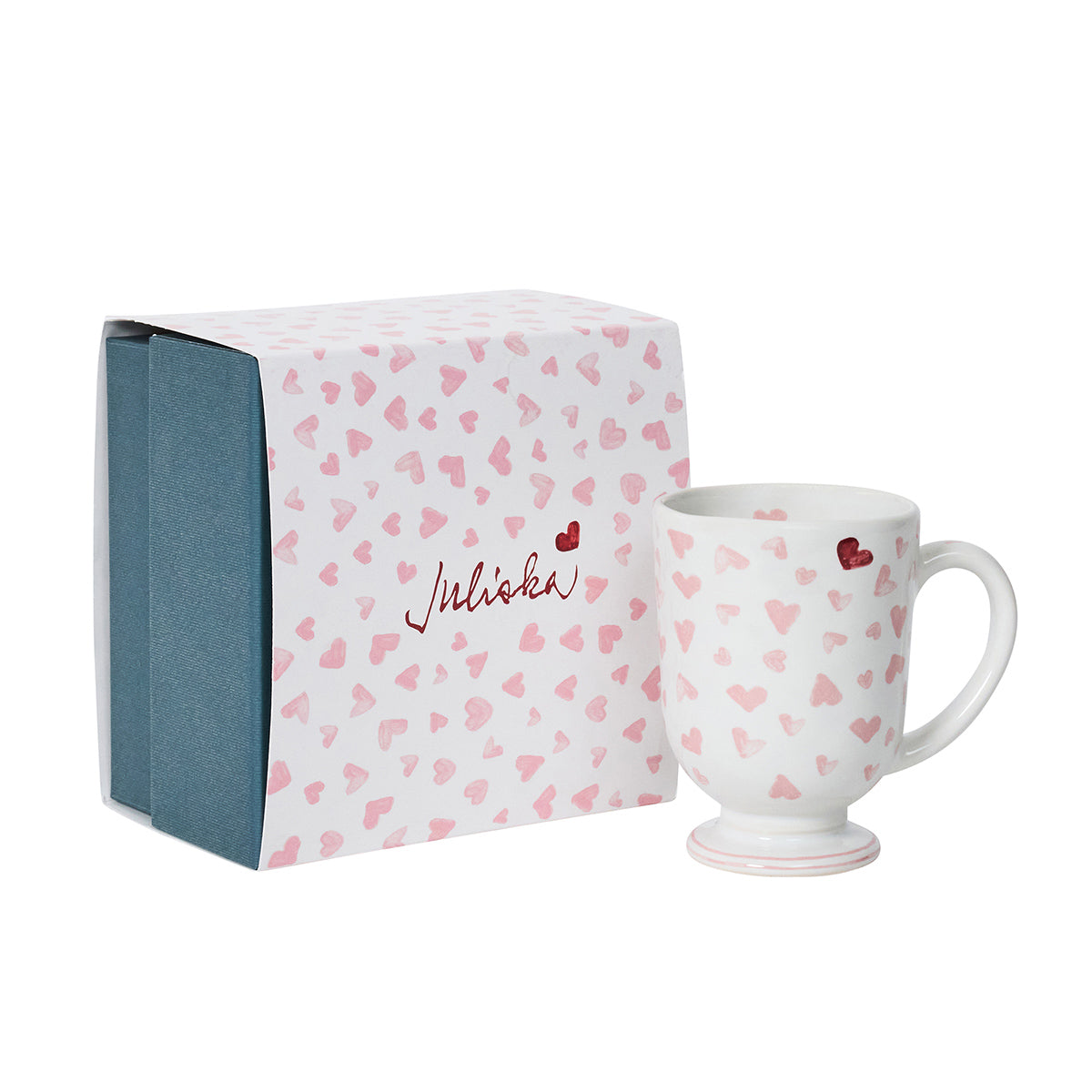 White mug with red heart patterns and matching packaging on a white background