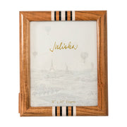 Wooden picture frame with decorative ribbon on a white background