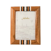 Wooden picture frame with decorative accents on a white background