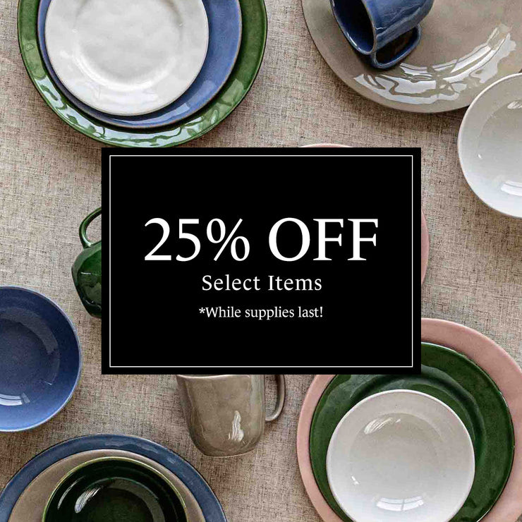 Puro ceramics laid out on a linen tablecloth. Text overlay that says "25% off select items while supplies last!"