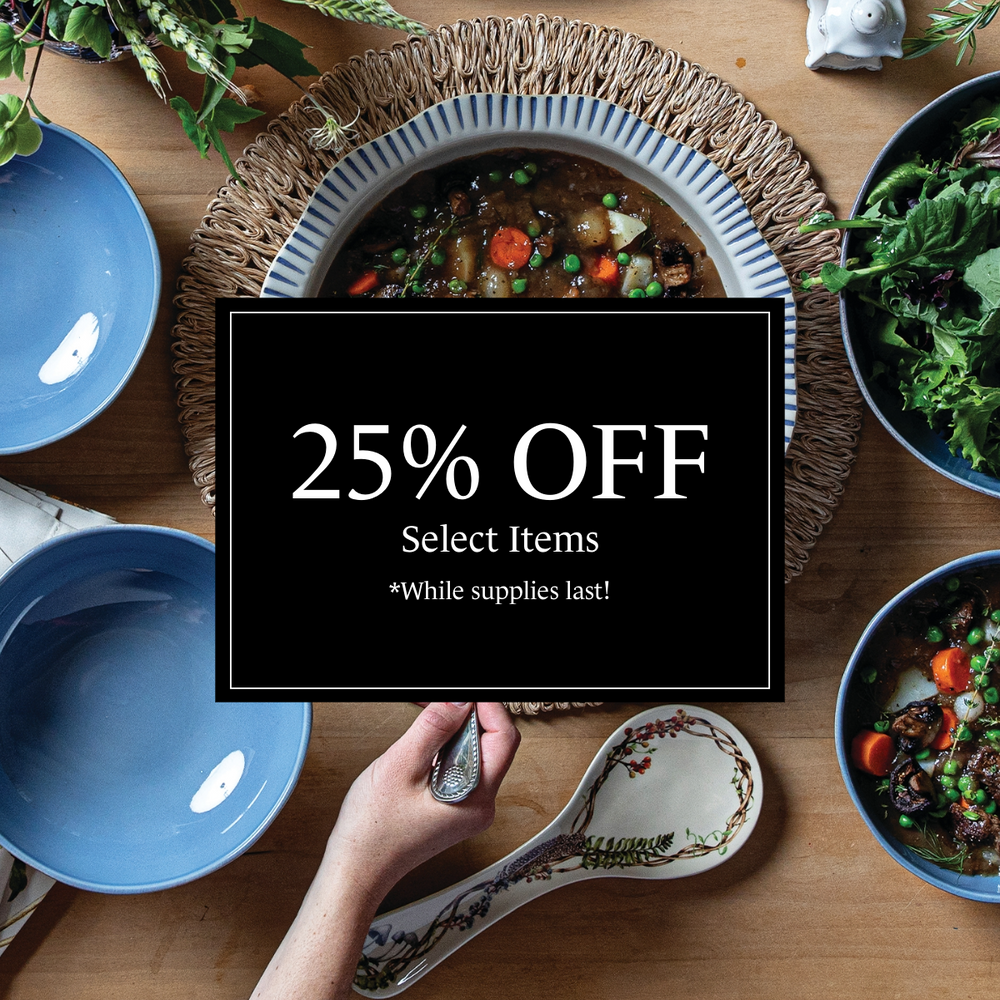 Table setting with plates and a promotional sign for 25% off select items.