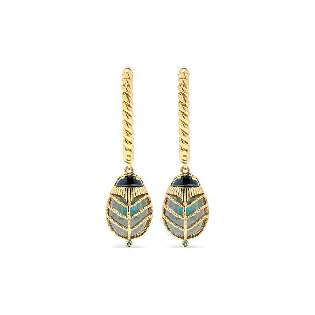 Exotic, regal and refined our stunning Scarab is an empowering talisman of renewal. The wings are rendered in luminescent, hand-carved and polished blue labradorite shell, a black agate is set for the head and 18K flash gold plated brass on radiant gold hoops.