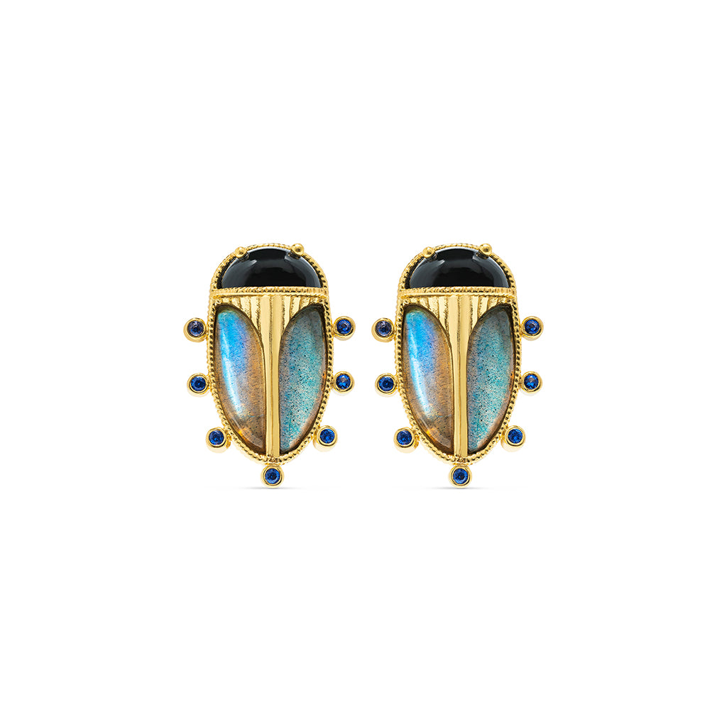 Pair of gold earrings with blue gemstones on a white background