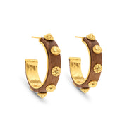 Pair of gold and wooden hoop earrings on a white background