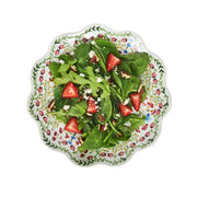 Salad with strawberries and nuts on a decorative plate with floral pattern