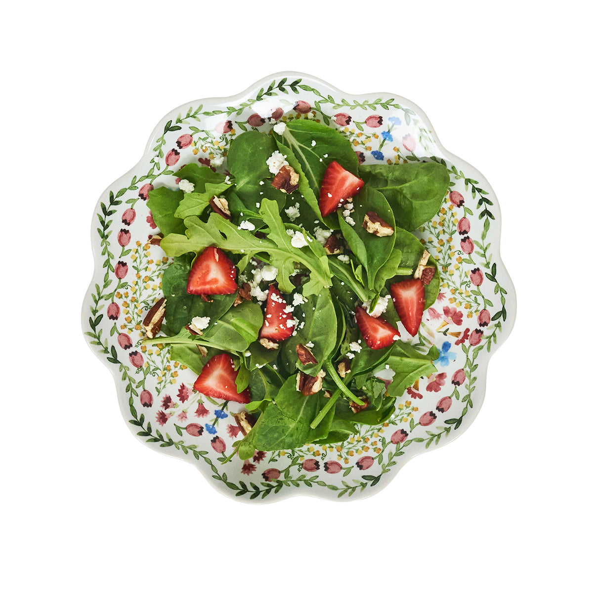 Salad with strawberries and nuts on a decorative plate with floral pattern