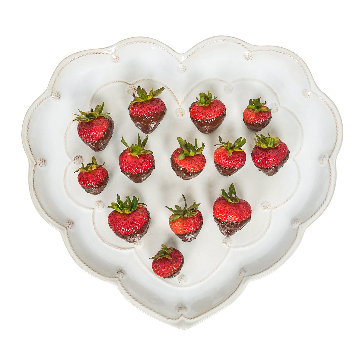 Heart-shaped white plate with strawberries on a white background