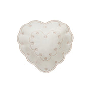Heart-shaped decorative plate with floral patterns on a white background