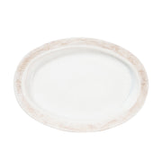White oval platter with decorative brown rim on a white background