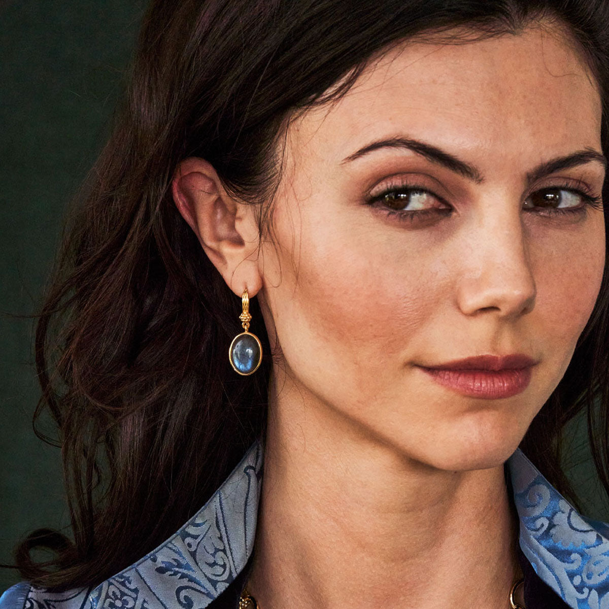 Close-up of a woman wearing an earring with a dark background