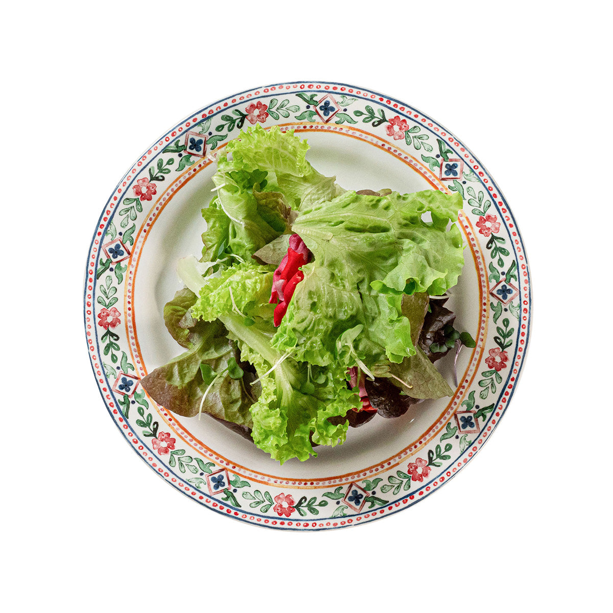 Decorative plate with a salad on a white background