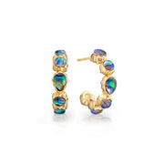 A pair of gold hoop earrings featuring bezel-set oval iridescent opal-like stones that shimmer with blue, green, and purple hues, displayed on a clean white background.