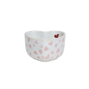 Heart-shaped ceramic bowl with pink heart patterns on a white background