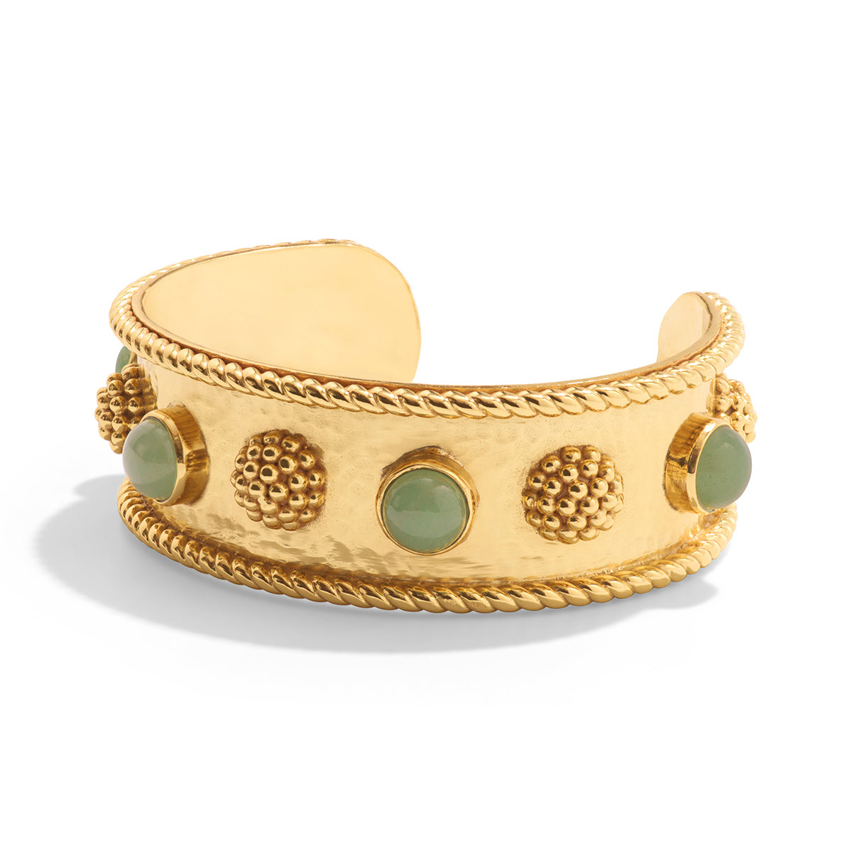 Gold bracelet with green stones on a white background