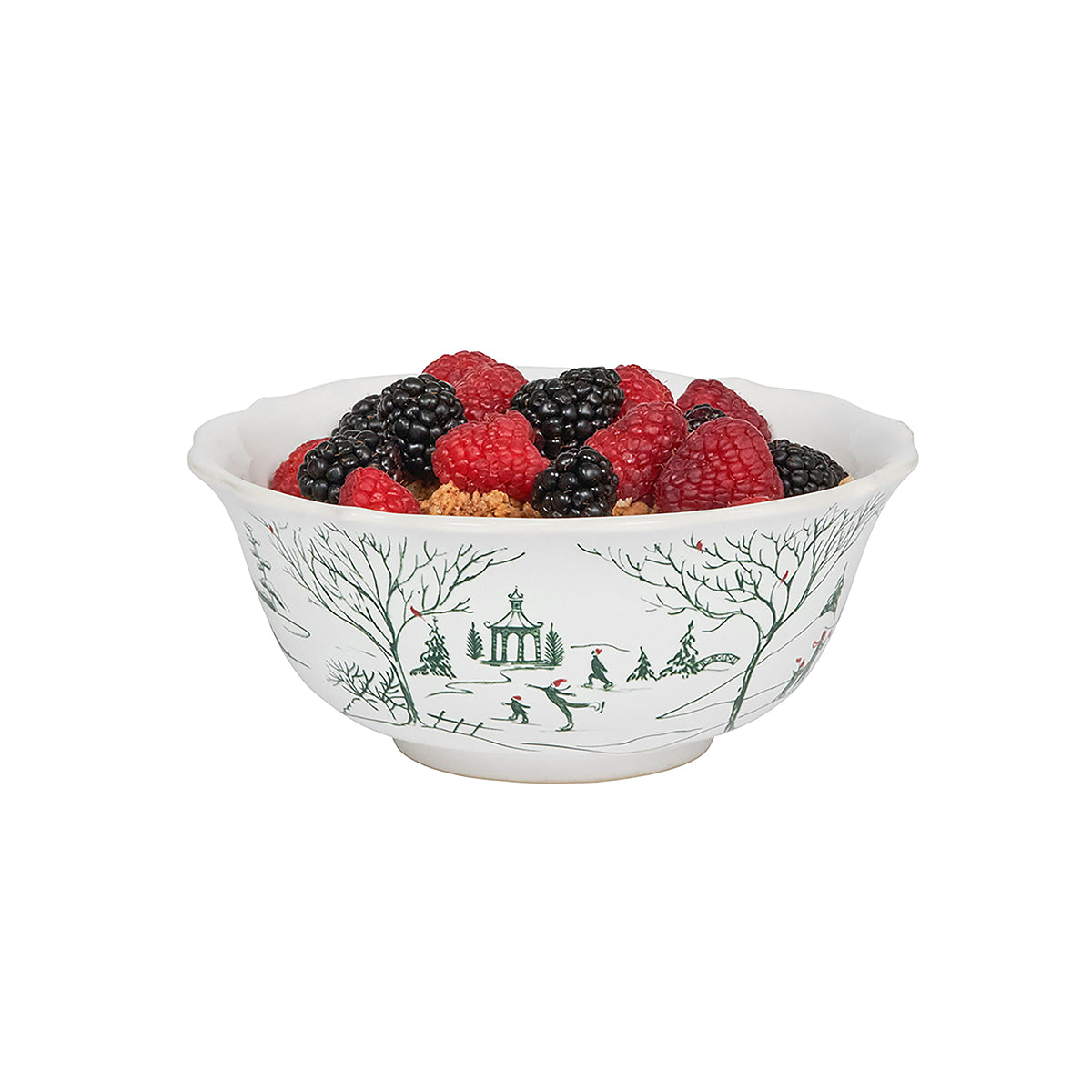 Decorative bowl with a winter scene design filled with berries on a white background