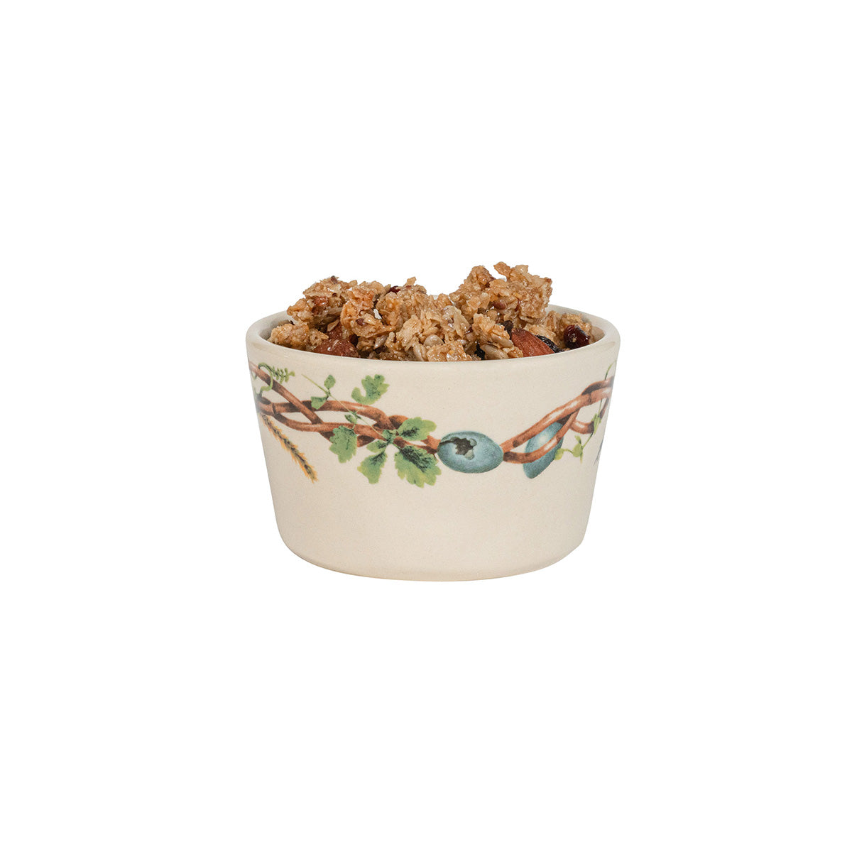 Ceramic bowl with nature-themed design filled with granola on a white background