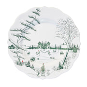 Decorative plate with winter scene design featuring trees, houses, and people.